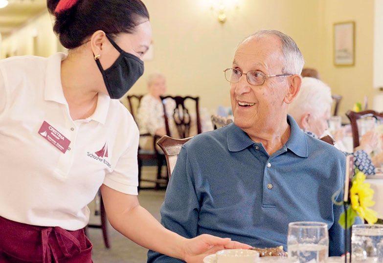 Man smiling at Schooner Estates employee