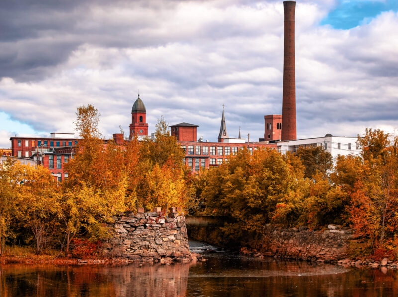 View of the mill along the Androscoggin River running through Lewiston and Auburn with visible fall foliage